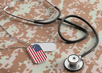 Stethoscope and dog tags on military camouflage